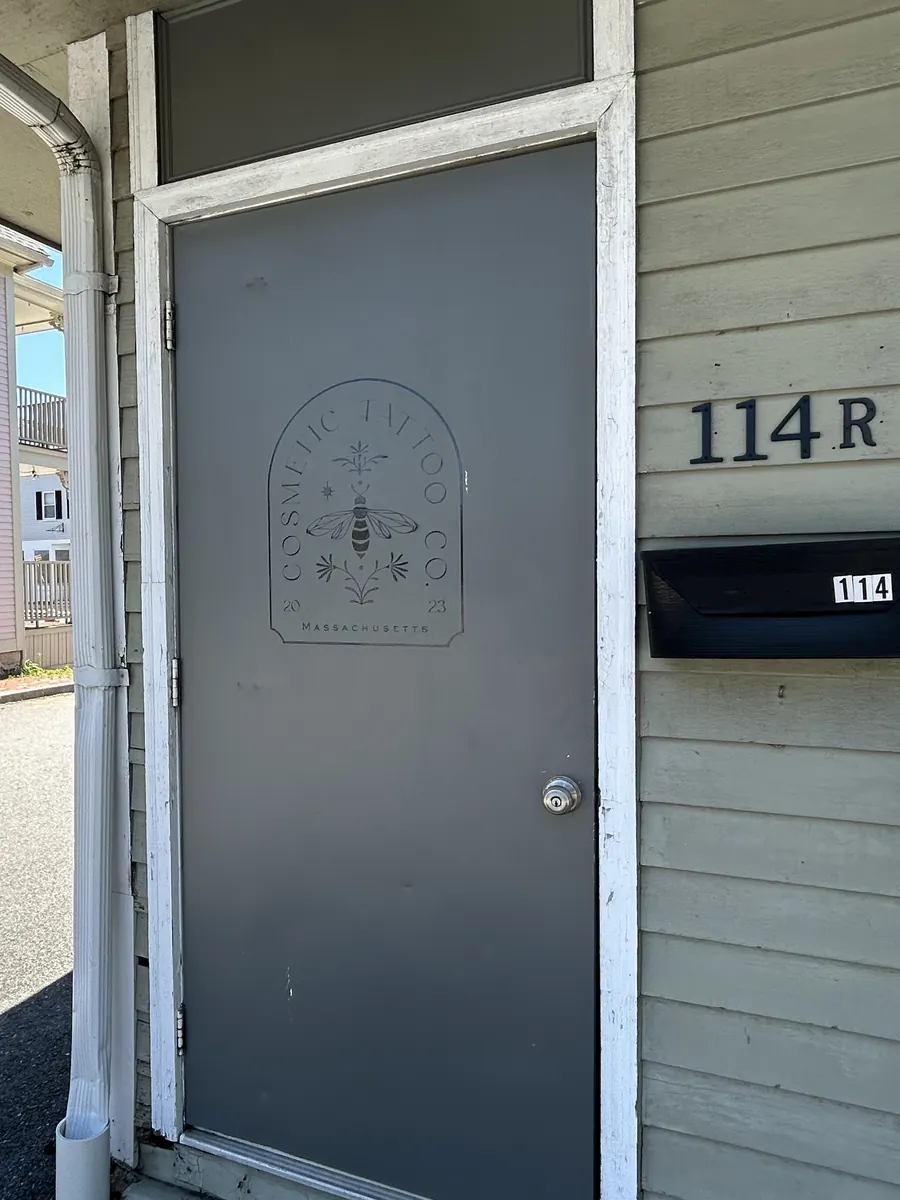 A gray door with 114R in large numbers beside it